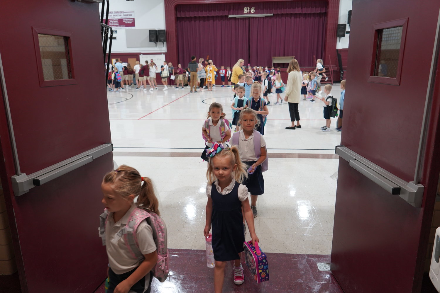 Students of St. George School in Hermann exit the gym after a morning assembly on their first day of school.